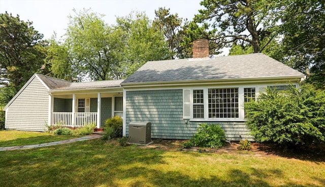 rear view of house featuring a lawn