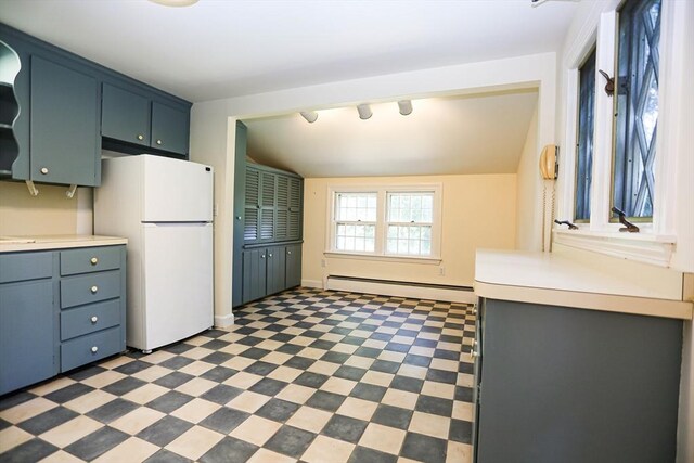 unfurnished living room featuring baseboard heating, hardwood / wood-style flooring, and a fireplace