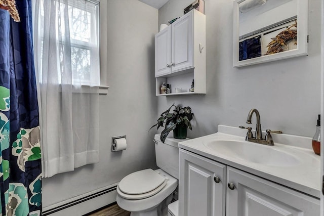 bathroom with toilet, a baseboard radiator, and vanity