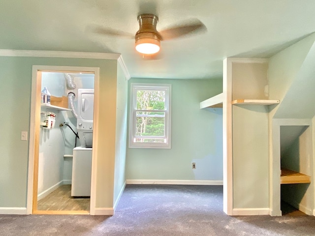 bonus room with stacked washer and clothes dryer, light carpet, and ceiling fan