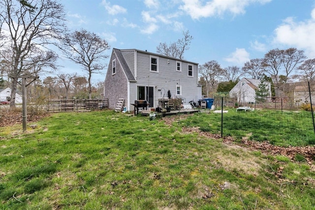 rear view of property featuring a yard