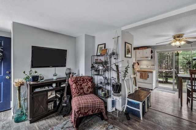 interior space with a textured ceiling, ceiling fan, and hardwood / wood-style floors