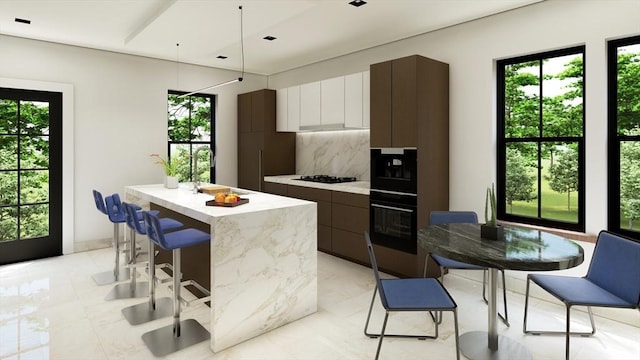 kitchen with dark brown cabinets, a center island, tasteful backsplash, black appliances, and white cabinets