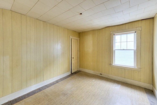 spare room with wooden walls