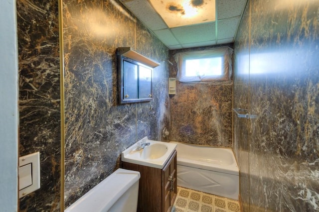 full bathroom featuring toilet, vanity, and a paneled ceiling
