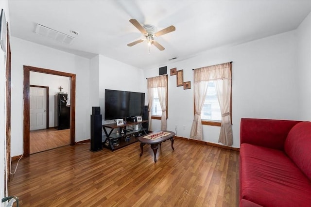 living room with hardwood / wood-style flooring and ceiling fan