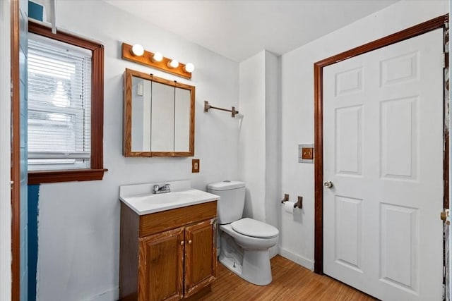 bathroom featuring hardwood / wood-style flooring, vanity, and toilet