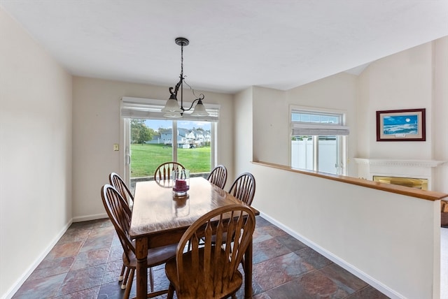 dining area with a healthy amount of sunlight and a chandelier