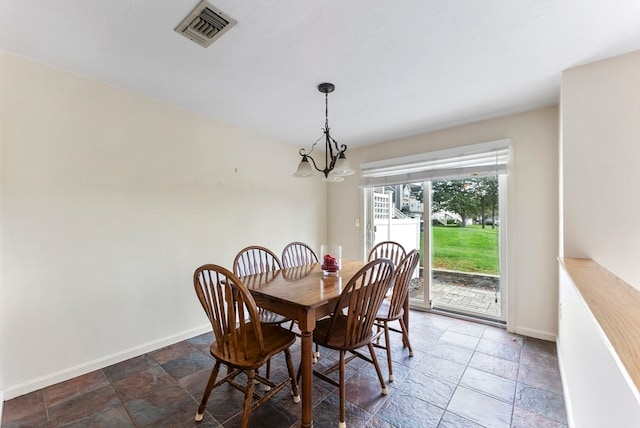 dining space with a chandelier