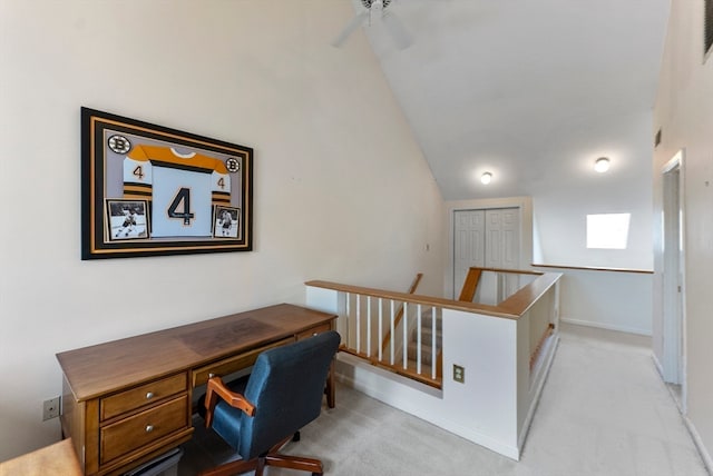 home office featuring vaulted ceiling, ceiling fan, and light colored carpet