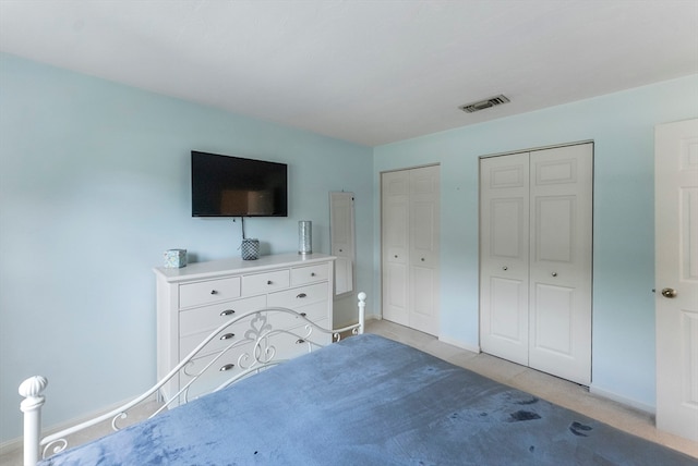 unfurnished bedroom featuring two closets