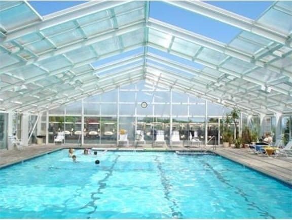 view of swimming pool featuring a lanai