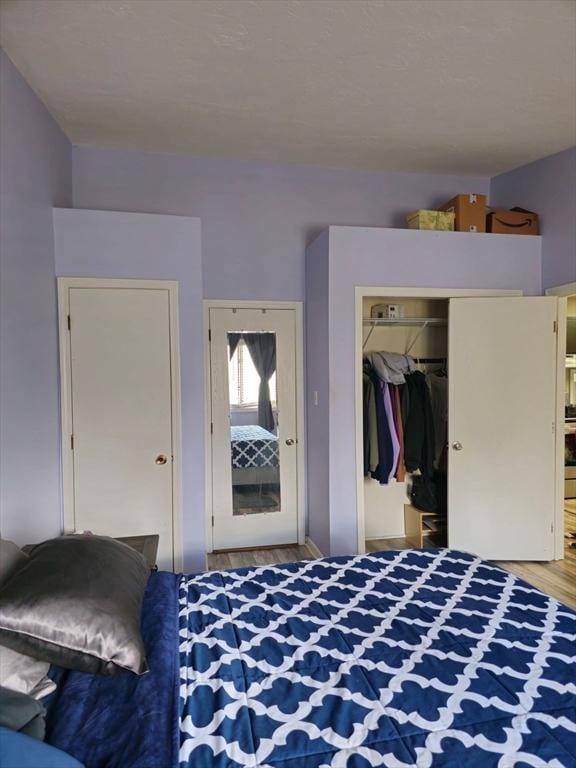bedroom featuring wood finished floors and a closet