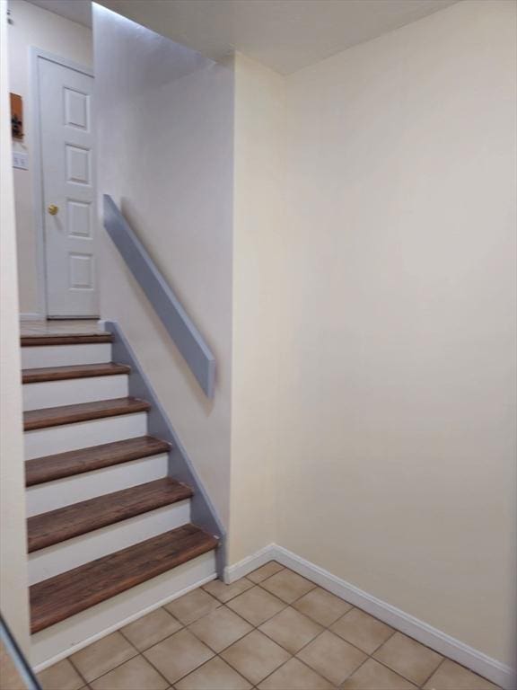 stairs with tile patterned flooring and baseboards