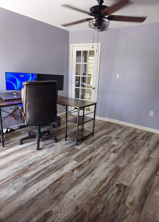 office with baseboards, wood finished floors, and a ceiling fan