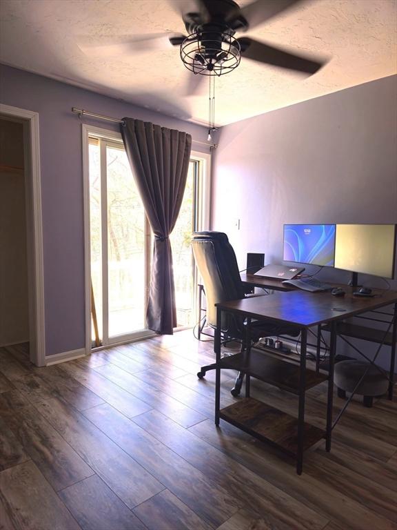 office with dark wood-type flooring and ceiling fan