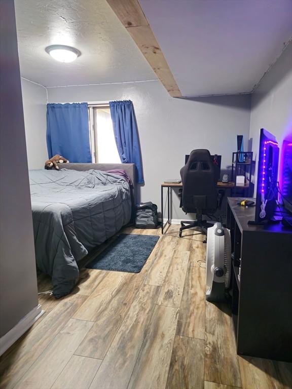 bedroom with hardwood / wood-style floors