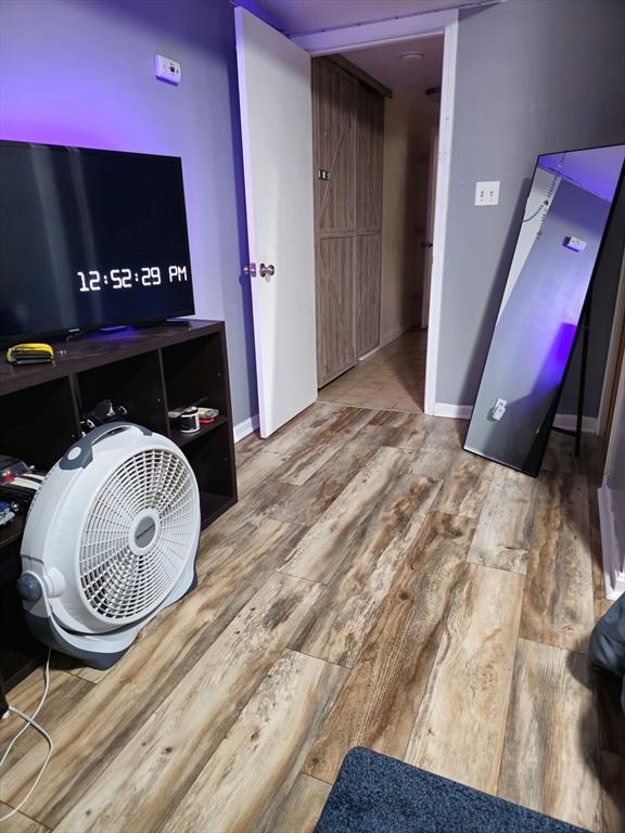 rec room featuring wood finished floors and baseboards