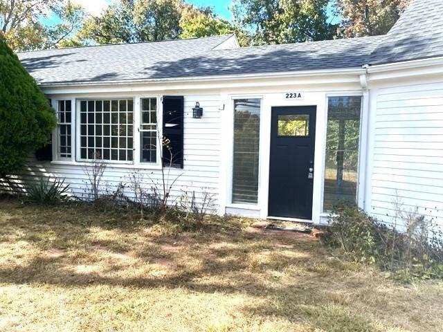 entrance to property with a lawn