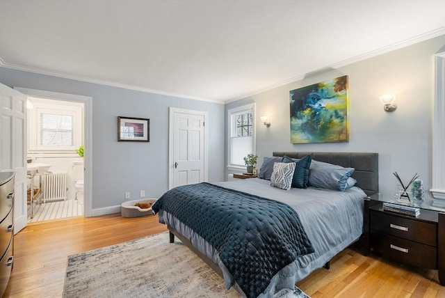 bedroom with ornamental molding, multiple windows, radiator heating unit, connected bathroom, and light hardwood / wood-style floors