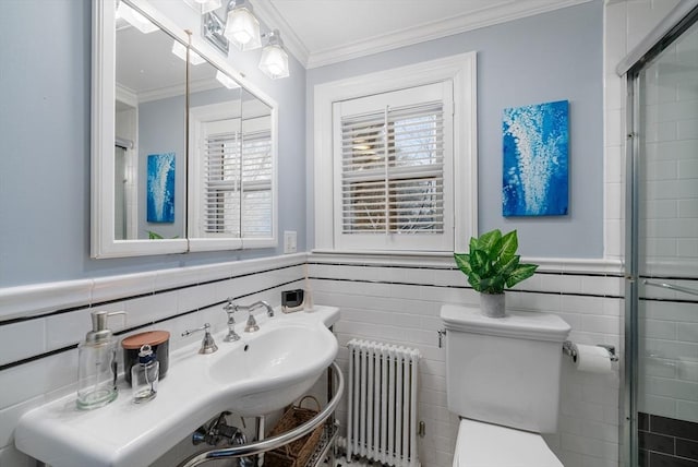 bathroom featuring radiator, toilet, tile walls, and ornamental molding