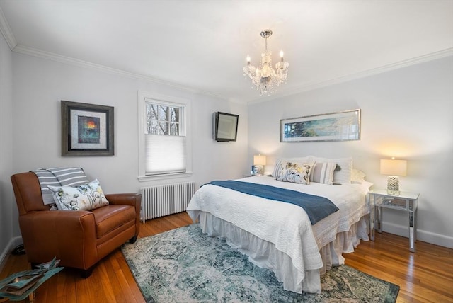 bedroom with hardwood / wood-style floors, crown molding, and radiator