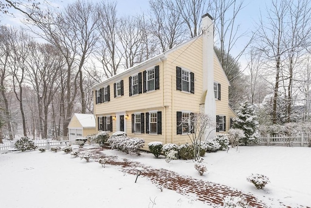 colonial house with an outbuilding and a garage