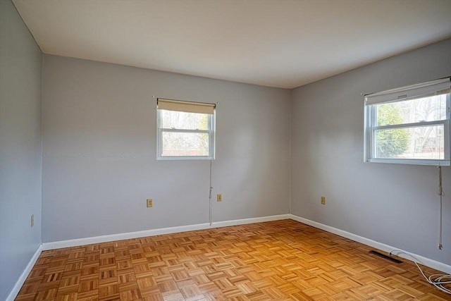 spare room with light parquet floors