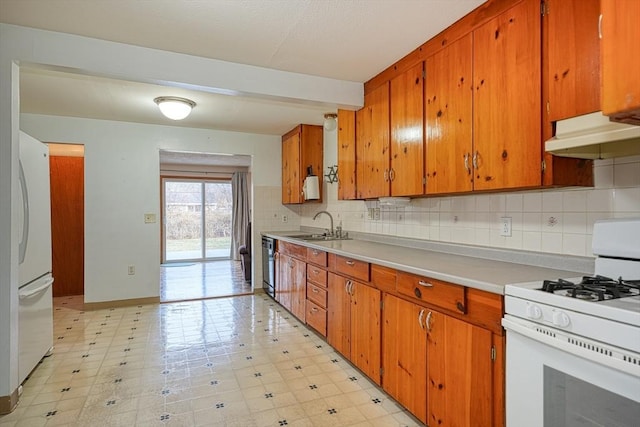 kitchen featuring sink, decorative backsplash, and white appliances