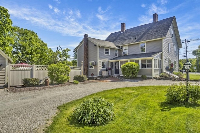 685 Main St, Wilbraham, MA 01095 - rear view of house featuring a chimney, curved driveway, and a sunroom
