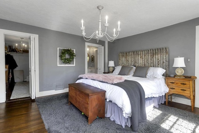 685 Main St, Wilbraham, MA 01095 - bedroom with a chandelier, wood finished floors, a walk in closet, baseboards, and a textured ceiling