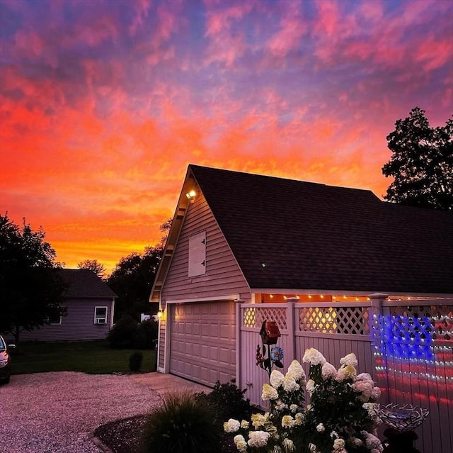 685 Main St, Wilbraham, MA 01095 - garage at dusk featuring fence and a garage