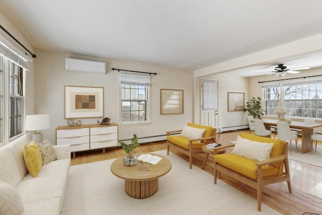 living area featuring a baseboard radiator, a wall unit AC, light hardwood / wood-style floors, and ceiling fan