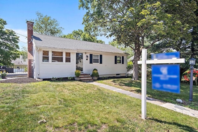 11 Worcester Pl, Holbrook, MA 02343 - view of front facade featuring a chimney and a front lawn