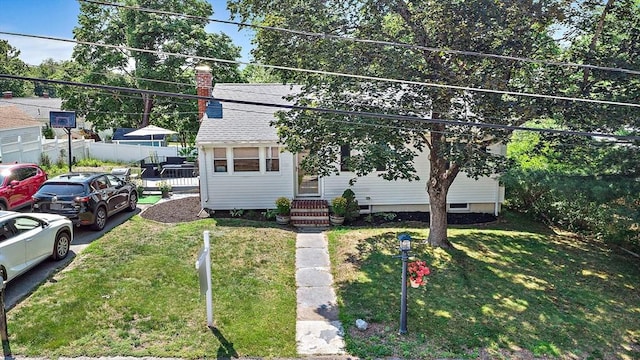 11 Worcester Pl, Holbrook, MA 02343 - view of front facade with a chimney, roof with shingles, and entry steps
