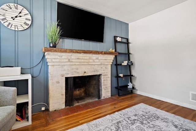 11 Worcester Pl, Holbrook, MA 02343 - living area featuring wood finished floors and a brick fireplace