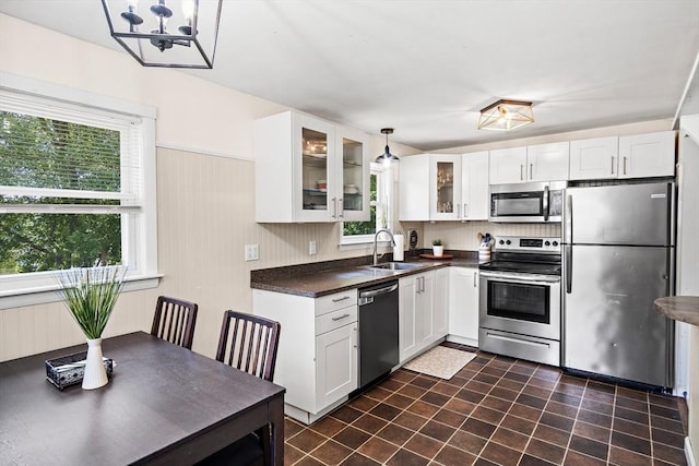 11 Worcester Pl, Holbrook, MA 02343 - kitchen with appliances with stainless steel finishes, dark countertops, glass insert cabinets, and white cabinetry