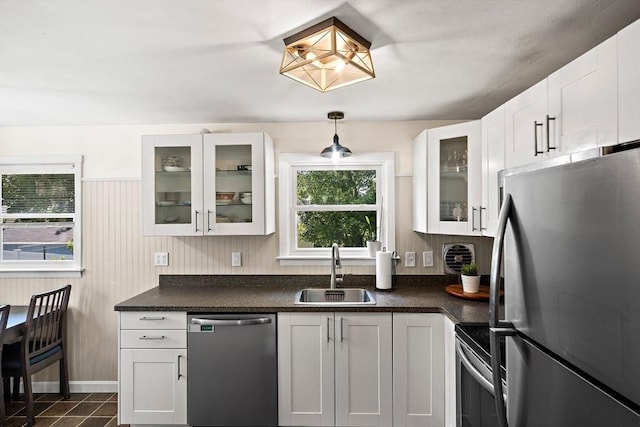 11 Worcester Pl, Holbrook, MA 02343 - kitchen with stainless steel appliances, white cabinets, dark countertops, glass insert cabinets, and dark tile patterned flooring