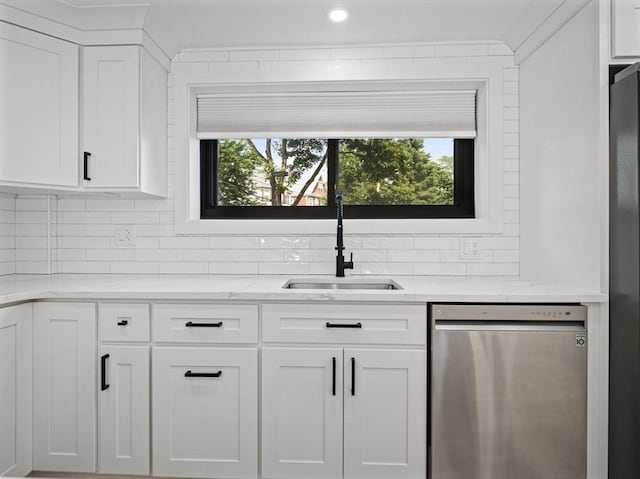 22 Chestnut Pl Unit G1, Brookline, MA 02445 - kitchen featuring stainless steel dishwasher, backsplash, white cabinetry, and light stone counters