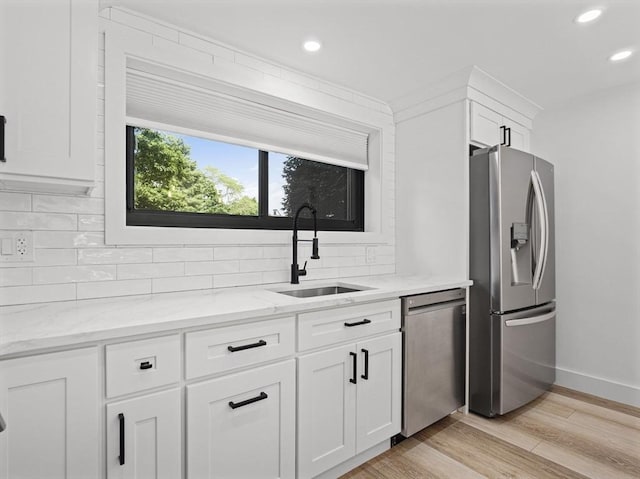 22 Chestnut Pl Unit G1, Brookline, MA 02445 - kitchen with appliances with stainless steel finishes, tasteful backsplash, recessed lighting, white cabinets, and light stone counters