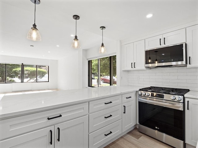 22 Chestnut Pl Unit G1, Brookline, MA 02445 - kitchen with stainless steel appliances, plenty of natural light, white cabinets, backsplash, and recessed lighting