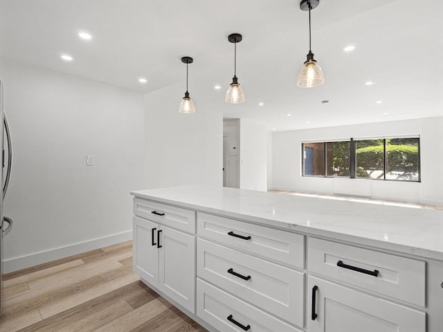 22 Chestnut Pl Unit G1, Brookline, MA 02445 - kitchen featuring light wood-style floors, recessed lighting, white cabinetry, light stone countertops, and hanging light fixtures