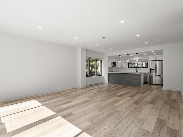 22 Chestnut Pl Unit G1, Brookline, MA 02445 - unfurnished living room featuring light wood finished floors and recessed lighting
