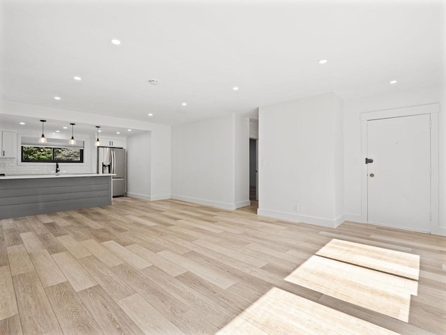 22 Chestnut Pl Unit G1, Brookline, MA 02445 - unfurnished living room with recessed lighting and light wood-style floors