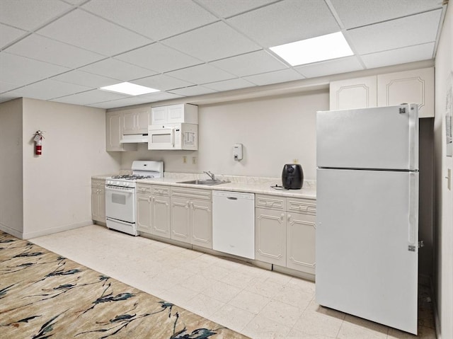 22 Chestnut Pl Unit G1, Brookline, MA 02445 - kitchen featuring white appliances, a paneled ceiling, light countertops, under cabinet range hood, and light floors