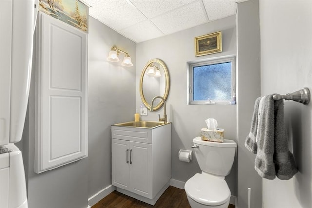 4 Myrtle Sq, Gloucester, MA 01930 - bathroom featuring vanity, a drop ceiling, toilet, baseboards, and wood finished floors