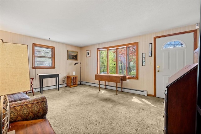 foyer featuring a baseboard heating unit, carpet flooring, and baseboards