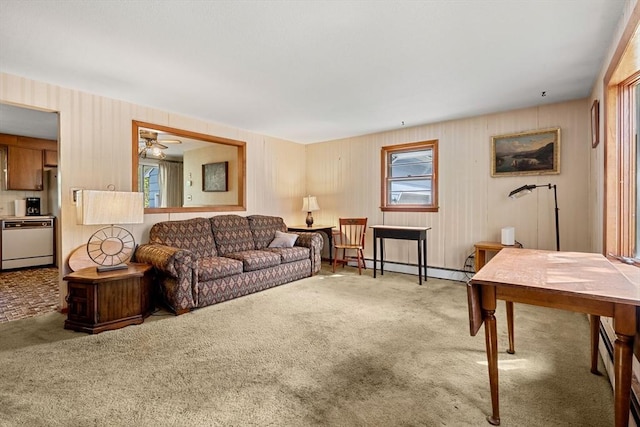 carpeted living room with baseboard heating and a ceiling fan