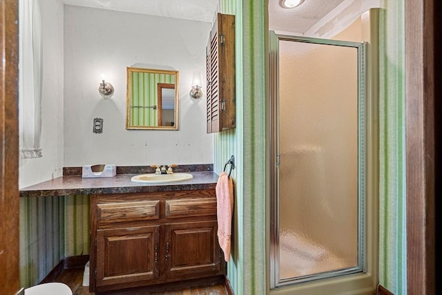 bathroom featuring a stall shower and vanity