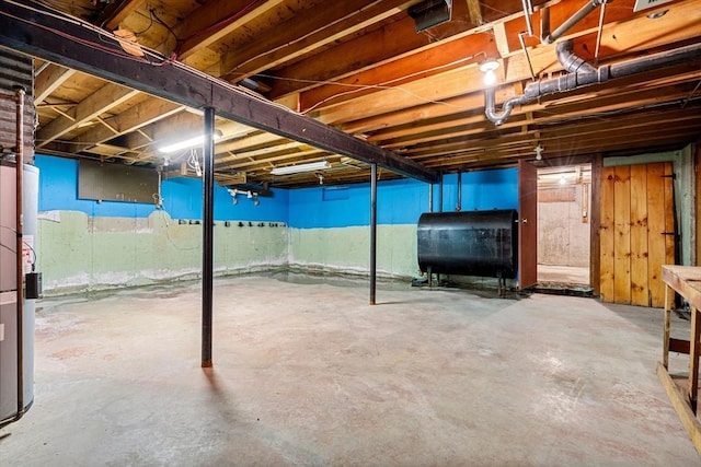 unfinished below grade area with oil tank and water heater